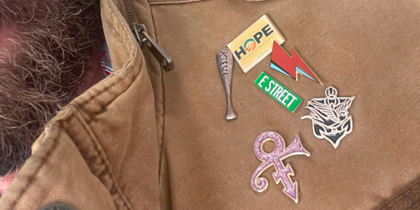Noland wearing his dad's Paddle & Thistle Society pin